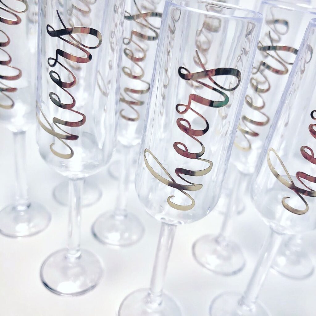 Mini champagne glasses with cheers vinyl lettering