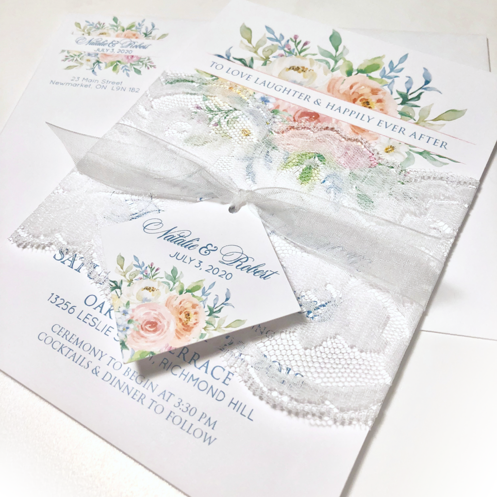 Watercoloured flowers and lace wedding invitation